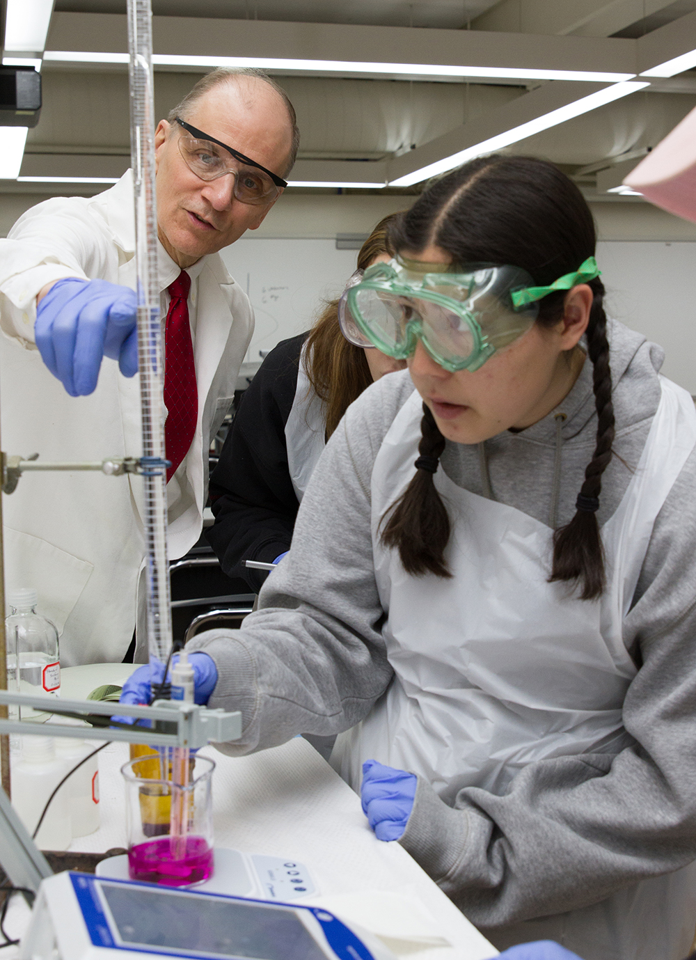 Instructor and student work in a lab