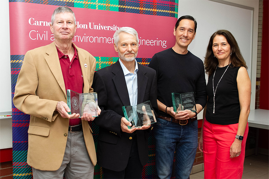 Martin Fertal, Dan Streyle, and Alejandro Gomez Rivera hold up their awards together.