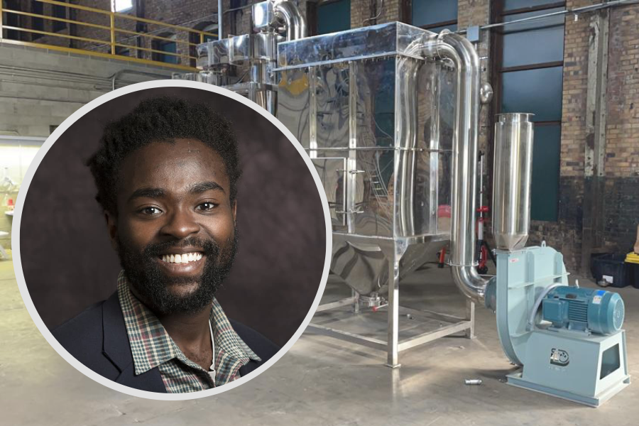 Kwaku Jyamfi's headshot in front of a machine at Farm to Flame Energy.